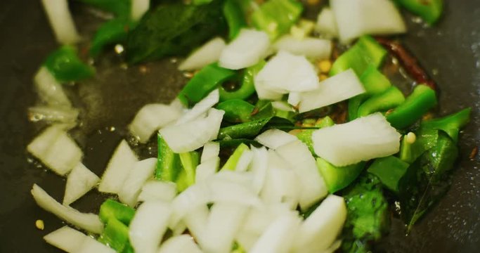 Slow motion shot of cooking a simple and easy vegetarian curry.