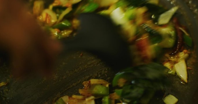 Slow motion shot of cooking a simple and easy vegetarian curry.