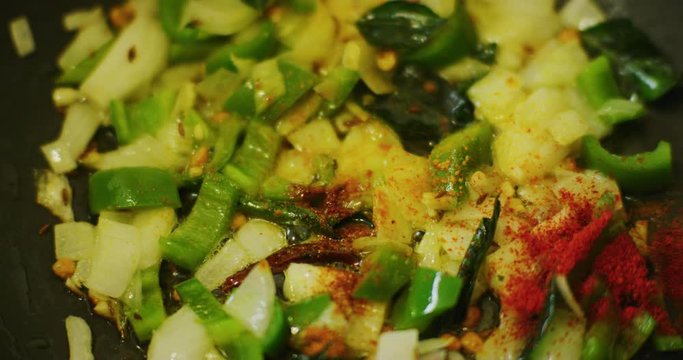 Slow motion shot of cooking a simple and easy vegetarian curry.