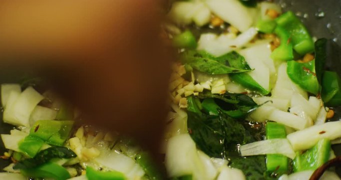 Slow motion shot of cooking a simple and easy vegetarian curry.