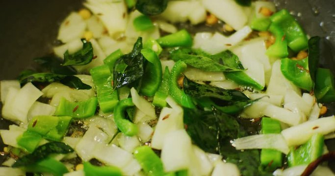 Slow motion shot of cooking a simple and easy vegetarian curry.