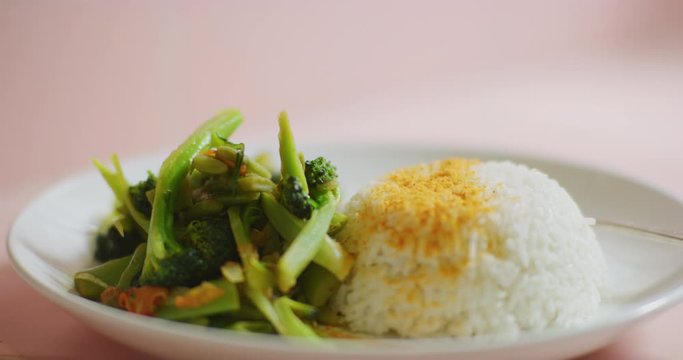 Slow motion shot of cooking and plating a simple and easy vegetarian curry.