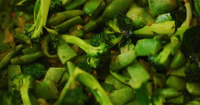 Slow motion shot of cooking a simple and easy vegetarian curry.