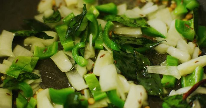 Slow motion shot of cooking a simple and easy vegetarian curry.