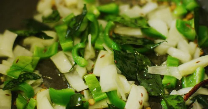 Slow motion shot of cooking a simple and easy vegetarian curry.