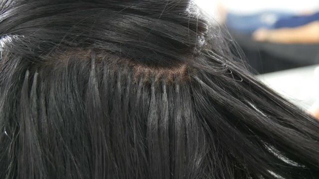 Long beautiful black hair curler stylist curls. Hair styling and curling. Hair Extension Capsules
