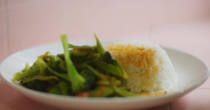 Slow motion shot of cooking and plating a simple and easy vegetarian curry.