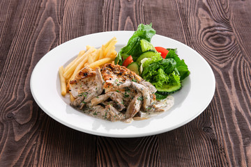 Grilled chicken fillet with oyster mushrooms, american fries and fresh vegetables