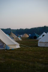 Fototapeta na wymiar Tent on a field at nightfall with blue sky