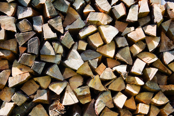 a lot of firewood outdoor, brown background