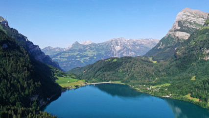 Klöntalersee lake in mountains. Kanton Glarus, Switzerland. Aerial view.