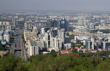 Obraz premium Almaty, Kazakhstan - August 24, 2019: View over the skyline of Almaty with slight smog clouds over the city.