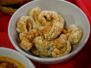 Closeup of brown crispy deep fried pork lard crackling (khaep mu) - famous and popular small side dish among the Thais
