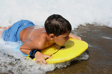 Boy with Board Reaching the Sand