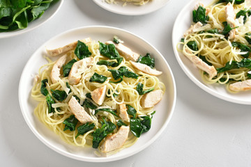 Spaghetti with spinach leaves, grilled chicken breast and cheese