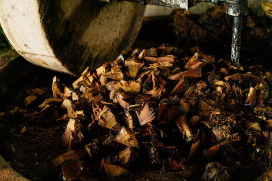 Burnt wood chips at iron shabby masher at beverage production