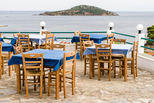 Tables in tavern by the Mediterranean sea,   Skyathos island, Greece