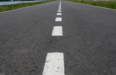 Obraz premium Dark asphalt road with marking lines. Tarmac texture