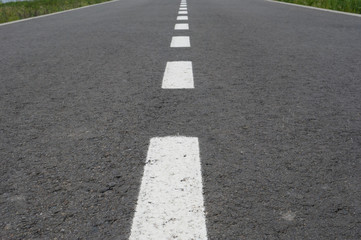 Dark asphalt road with marking lines. Tarmac texture