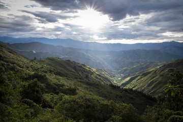 Naklejka premium Beautiful mountainous field reflected by the sun. In the center an extensive valley covered with vegetation. South America