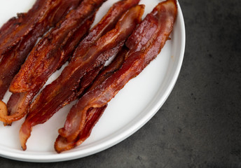 Cooked Bacon Stripes on Dark Background