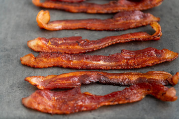 Cooked Bacon Stripes on Dark Background