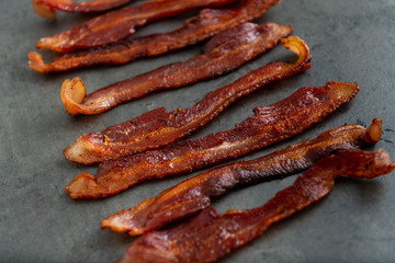Cooked Bacon Stripes on Dark Background
