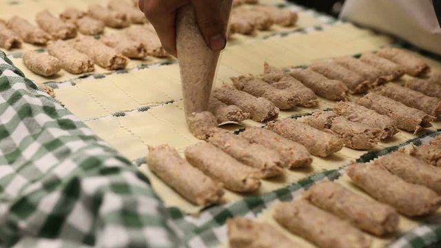 Process of stuffing cannelloni with minced meat on restaurant kitchen 