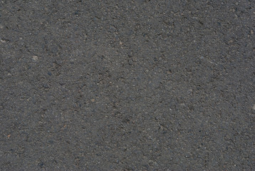 Smooth asphalt road. Tarmac dark grey grainy road background. Top view grunge rough surface