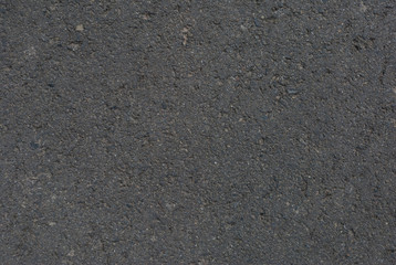 Smooth asphalt road. Tarmac dark grey grainy road background. Top view grunge rough surface