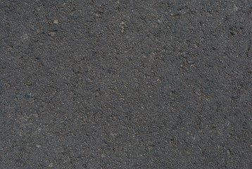 Smooth asphalt road. Tarmac dark grey grainy road background. Top view grunge rough surface