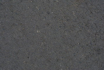 Smooth asphalt road. Tarmac dark grey grainy road background. Top view grunge rough surface