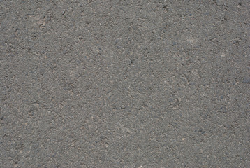 Smooth asphalt road. Tarmac dark grey grainy road background. Top view grunge rough surface