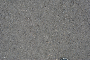 Smooth asphalt road. Tarmac dark grey grainy road background. Top view grunge rough surface