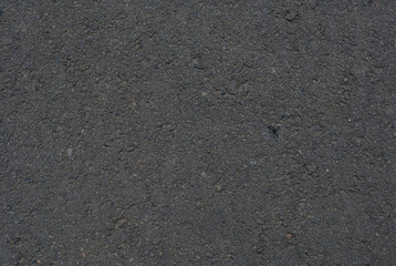 Smooth asphalt road. Tarmac dark grey grainy road background. Top view grunge rough surface