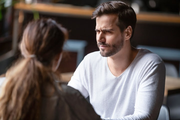 Doubting dissatisfied man looking at woman, bad first date concept