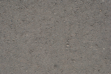 Smooth asphalt road. Tarmac dark grey grainy road background. Top view grunge rough surface