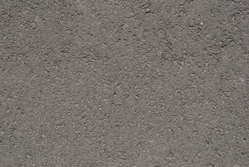 Smooth asphalt road. Tarmac dark grey grainy road background. Top view grunge rough surface