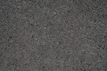 Smooth asphalt road. Tarmac dark grey grainy road background. Top view grunge rough surface