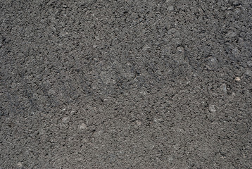 Smooth asphalt road. Tarmac dark grey grainy road background. Top view grunge rough surface