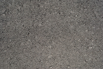 Smooth asphalt road. Tarmac dark grey grainy road background. Top view grunge rough surface