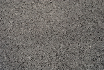 Smooth asphalt road. Tarmac dark grey grainy road background. Top view grunge rough surface