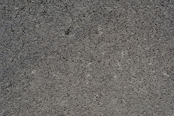 Smooth asphalt road. Tarmac dark grey grainy road background. Top view grunge rough surface