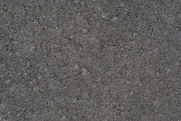 Smooth asphalt road. Tarmac dark grey grainy road background. Top view grunge rough surface