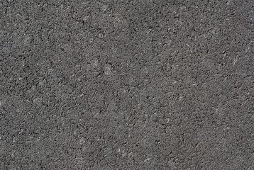 Smooth asphalt road. Tarmac dark grey grainy road background. Top view grunge rough surface