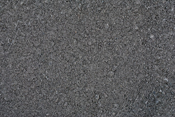 Smooth asphalt road. Tarmac dark grey grainy road background. Top view grunge rough surface