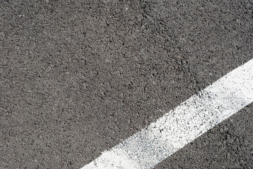 Asphalt texture with white line and tire marks . Top view
