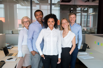 Portrait of smiling diverse employee look at camera making picture