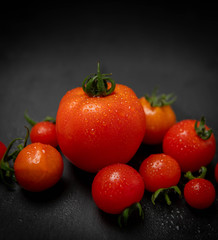 Freshly Picked Various Tomatoes on Dark Background with Room for Text