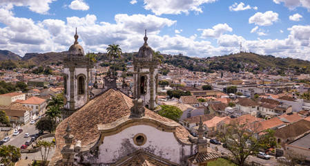 Fototapeta na wymiar Drone aerial view of Sao Joao del Rei city, Minas Gerais, Brazil with church of Sao Francisco de Assis in sunny summer day. Baroque catholic heritage built with the artist Aleijadinho.